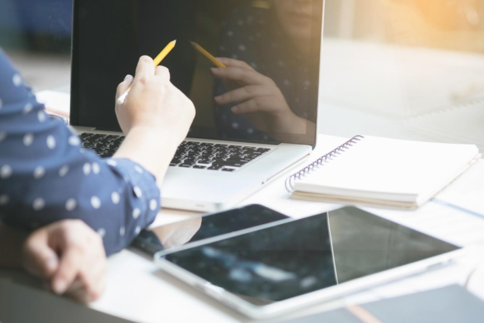 Financial analyst reviewing complex spreadsheet models on dual monitors